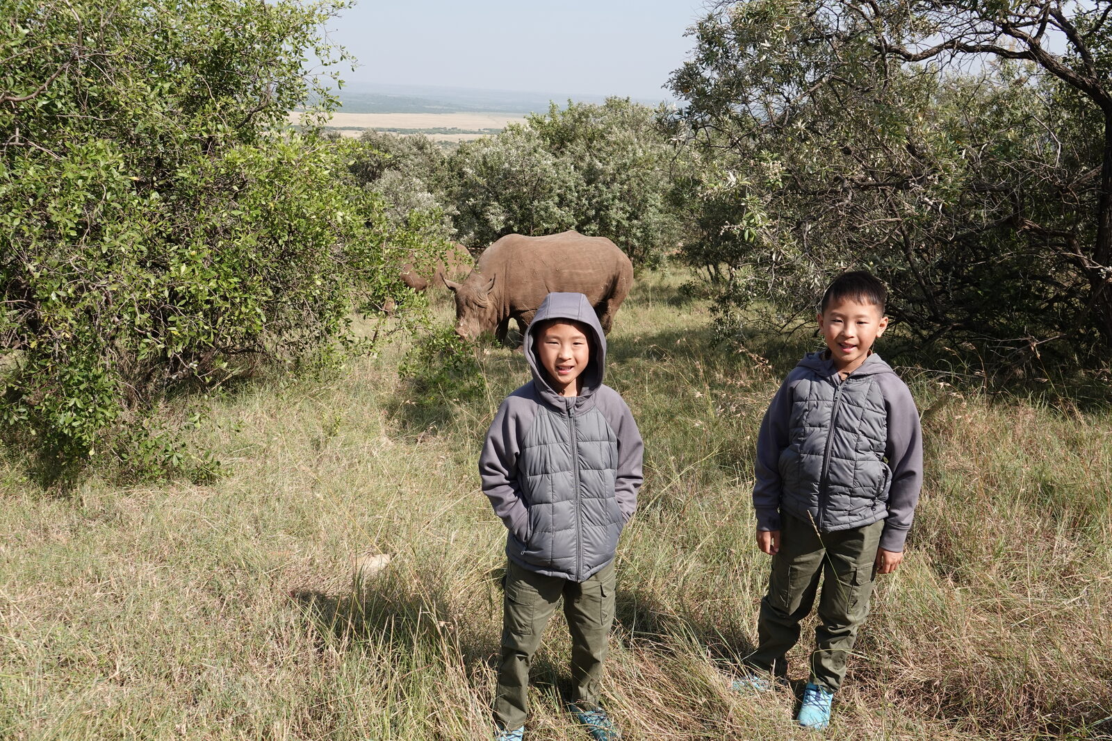 Our boys with a white rhino behind them at Ol Choro Oiroua Conservancy, with rangers nearby